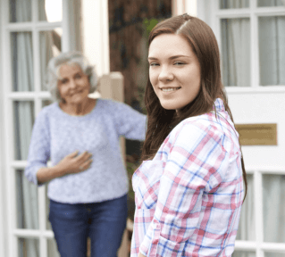 Teenager doing shopping for senior woman