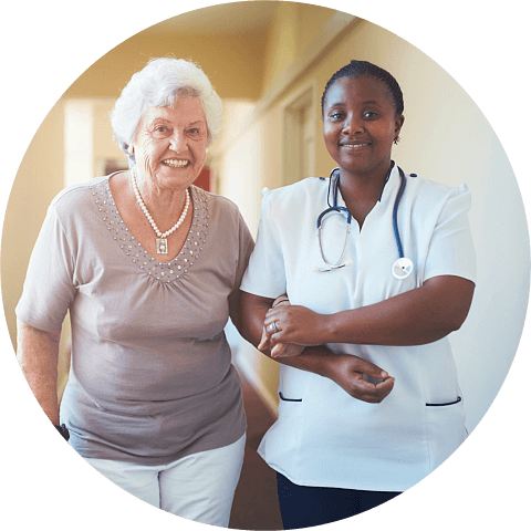 Caring female nurse assisting a senior patient to walk
