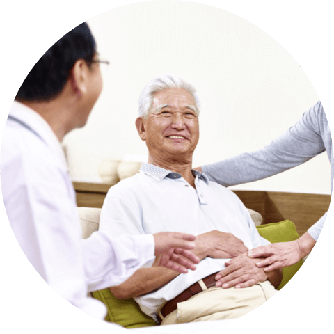 Senior asian patient being taken care of by his wife and a family doctor