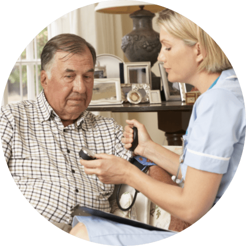 Retired senior man having health check with nurse at home