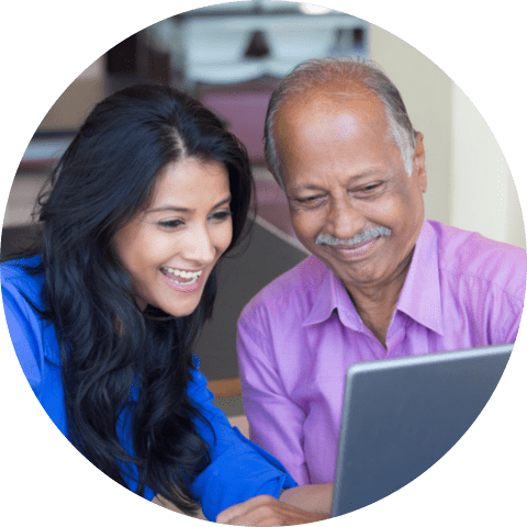 Sitting young women showing elderly to use laptop