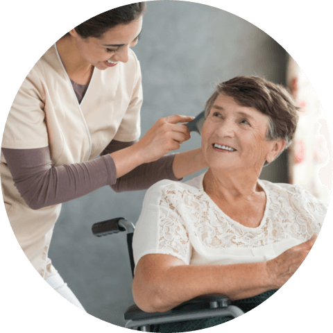 caregiver combing the hair of a senior